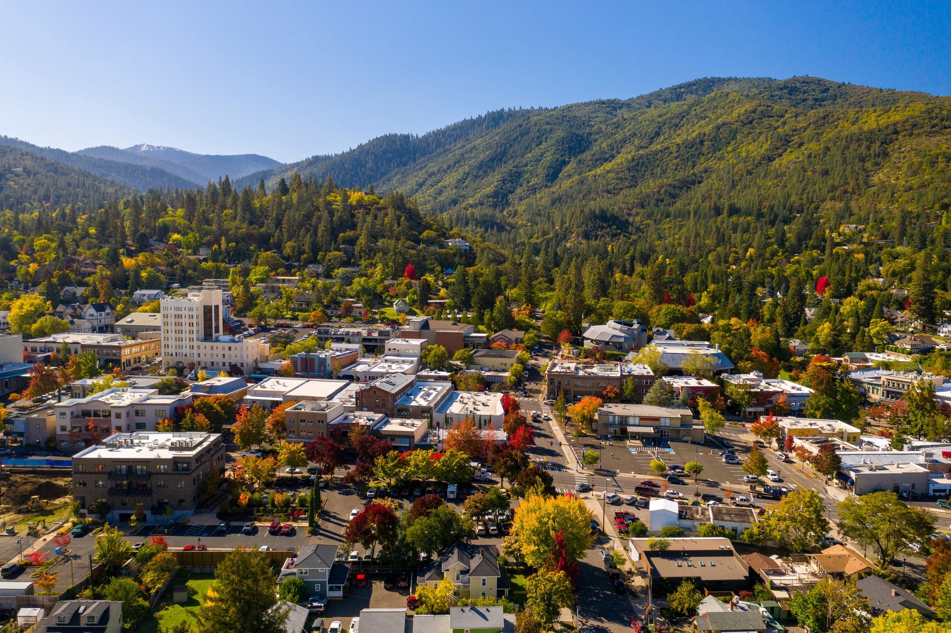 An aerial view of a small town surrounded by mountains.