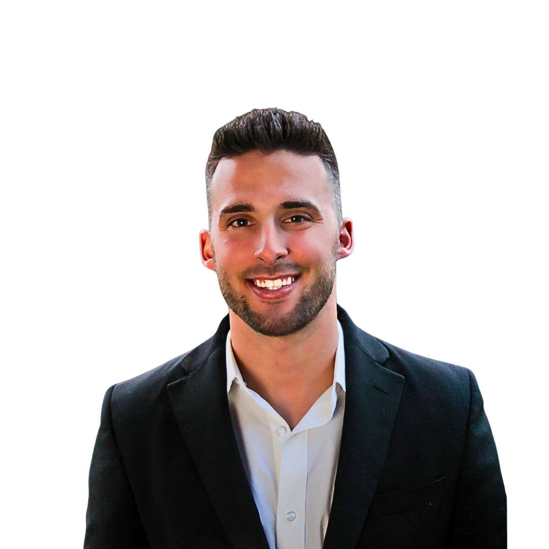 A man in a suit and white shirt is smiling for the camera.
