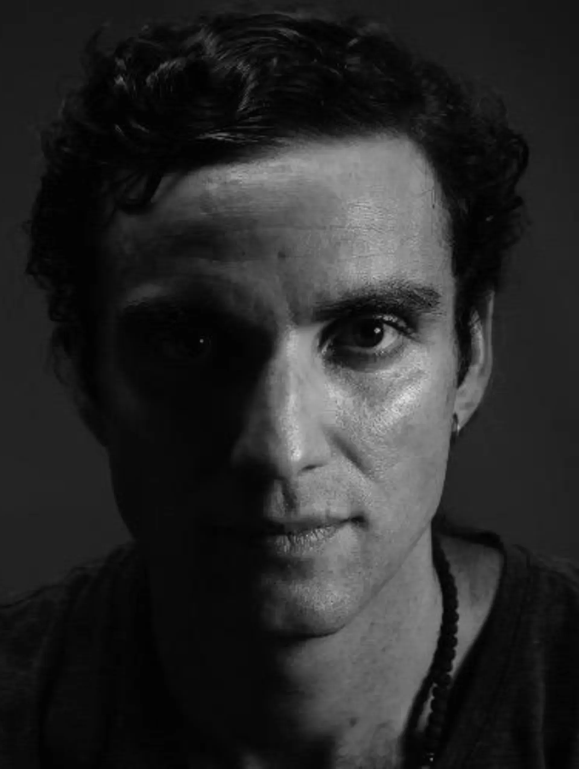Un primer plano del rostro de un hombre en una fotografía en blanco y negro.