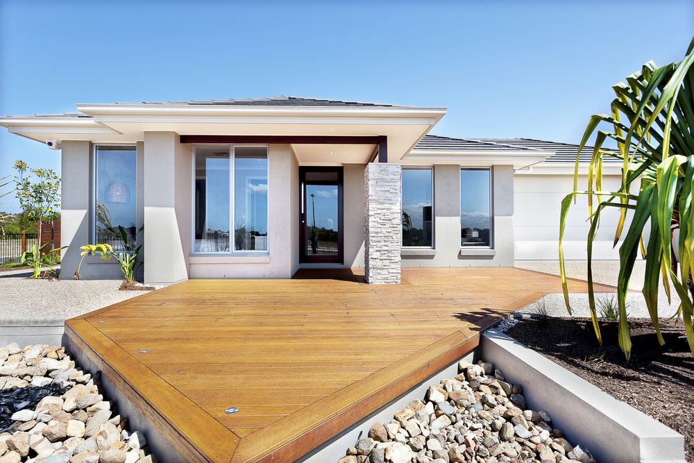 Modern, Single-story House With a Wooden Deck and Gravel Landscaping  — Property Transfer Professionals in Wyong, NSW