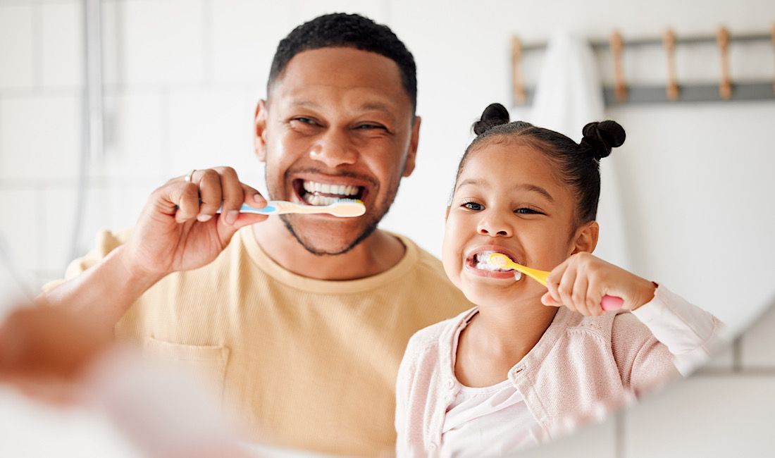 Dad and daughter brushing their teeth together in Salinas, CA.