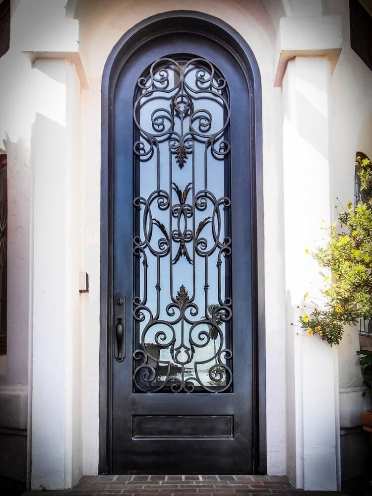 A black door with a wrought iron design on it