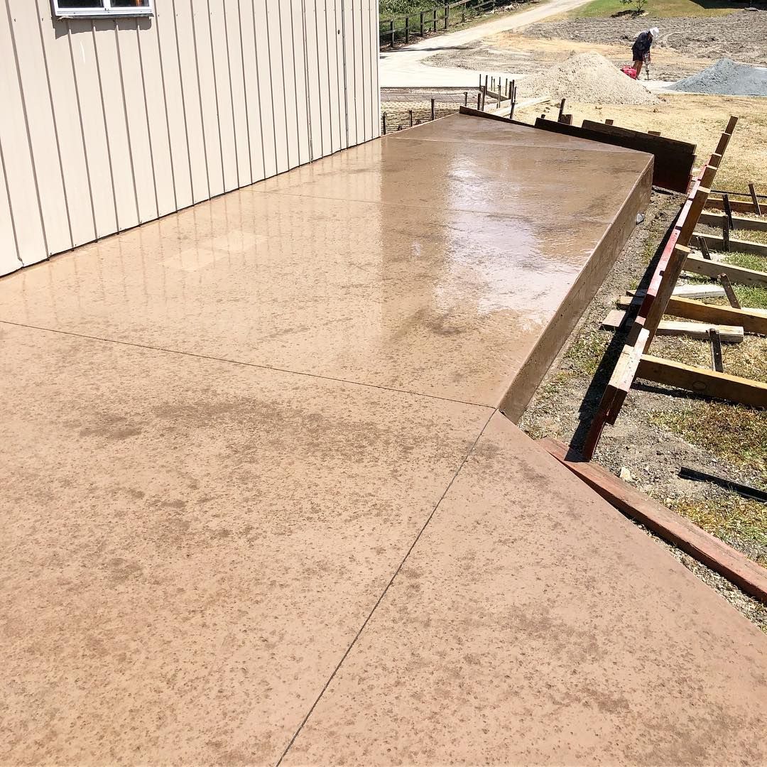 Freshly Poured Concrete Patio Next to a Cream-coloured Building — Sand & Stone in Worongary, QLD