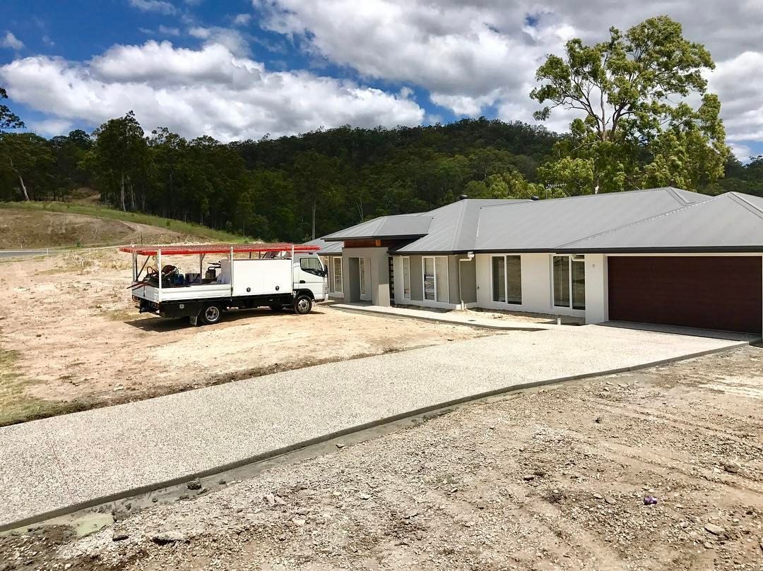 A White Service Truck Parked on an Unlandscaped Lot — Sand & Stone in Worongary, QLD