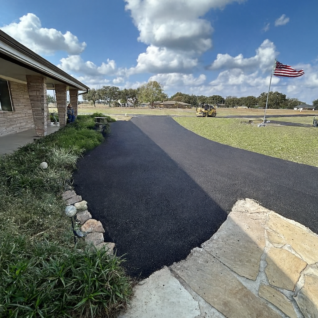 Asphalt Roller Compacting Fresh Black Asphalt on A Paved Surface — Sealy, TX — Sealy Paving, Inc. Asphalt Roller Compacting Fresh Black Asphalt on A Paved Surface — Sealy, TX — Sealy Paving, Inc.