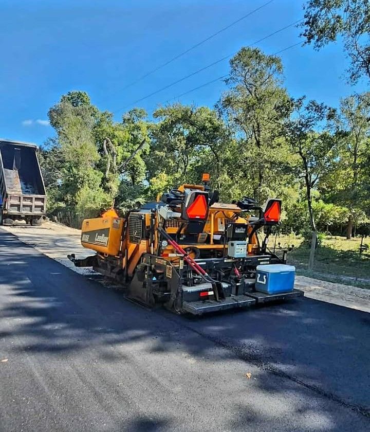 Measuring Wheel on A Freshly Paved Road — Sealy, TX — Sealy Paving, Inc. Measuring Wheel on A Freshly Paved Road — Sealy, TX — Sealy Paving, Inc.