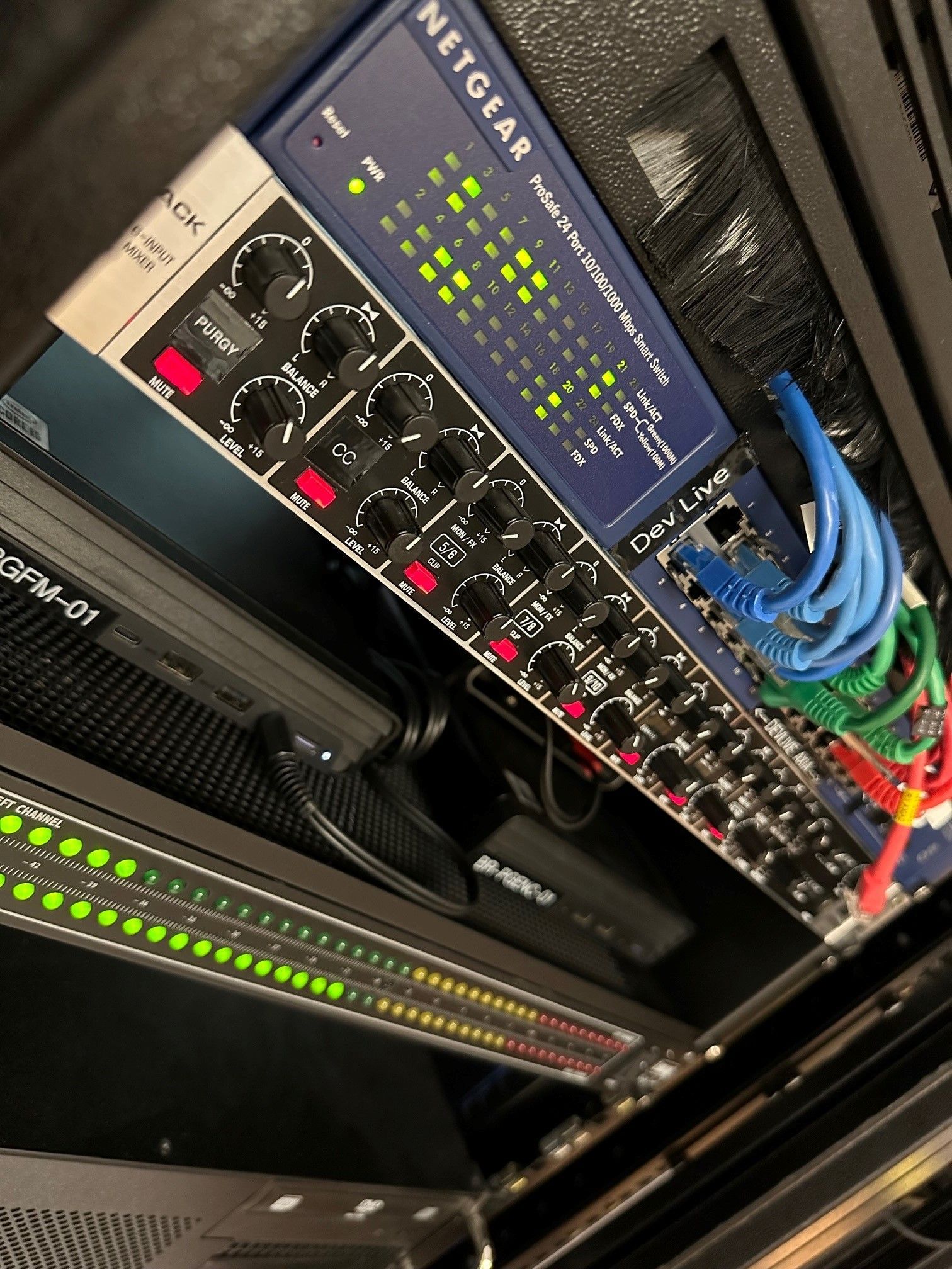 A netgear router is sitting on top of a server rack.