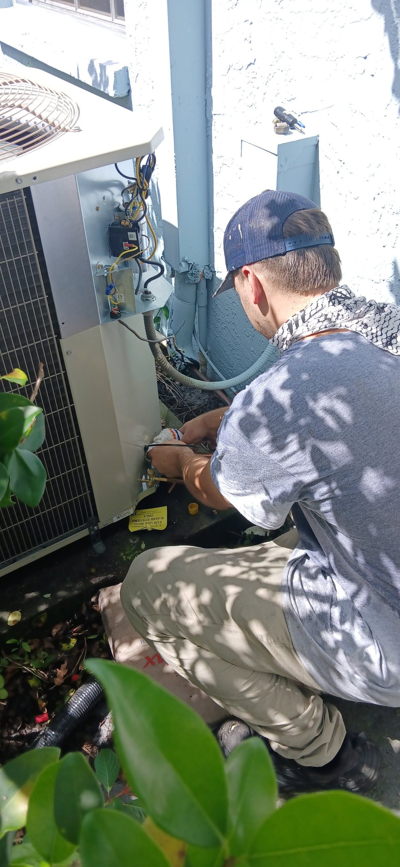 Open server cabinet with exposed wiring, circuit boards, and metal components outdoors.