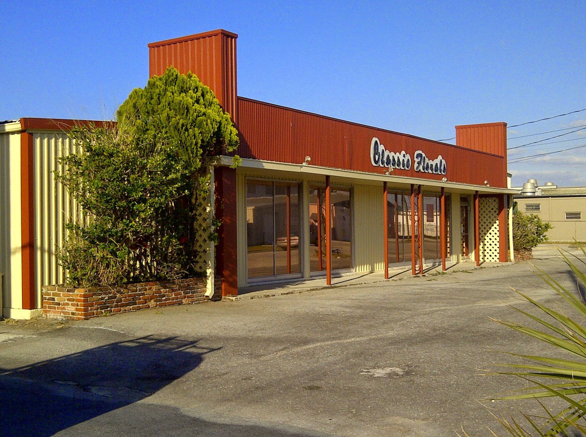 Small red storefront with glass windows and a sign reading “China Ranch” in a desert setting