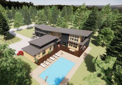 an aerial view of a house with a swimming pool