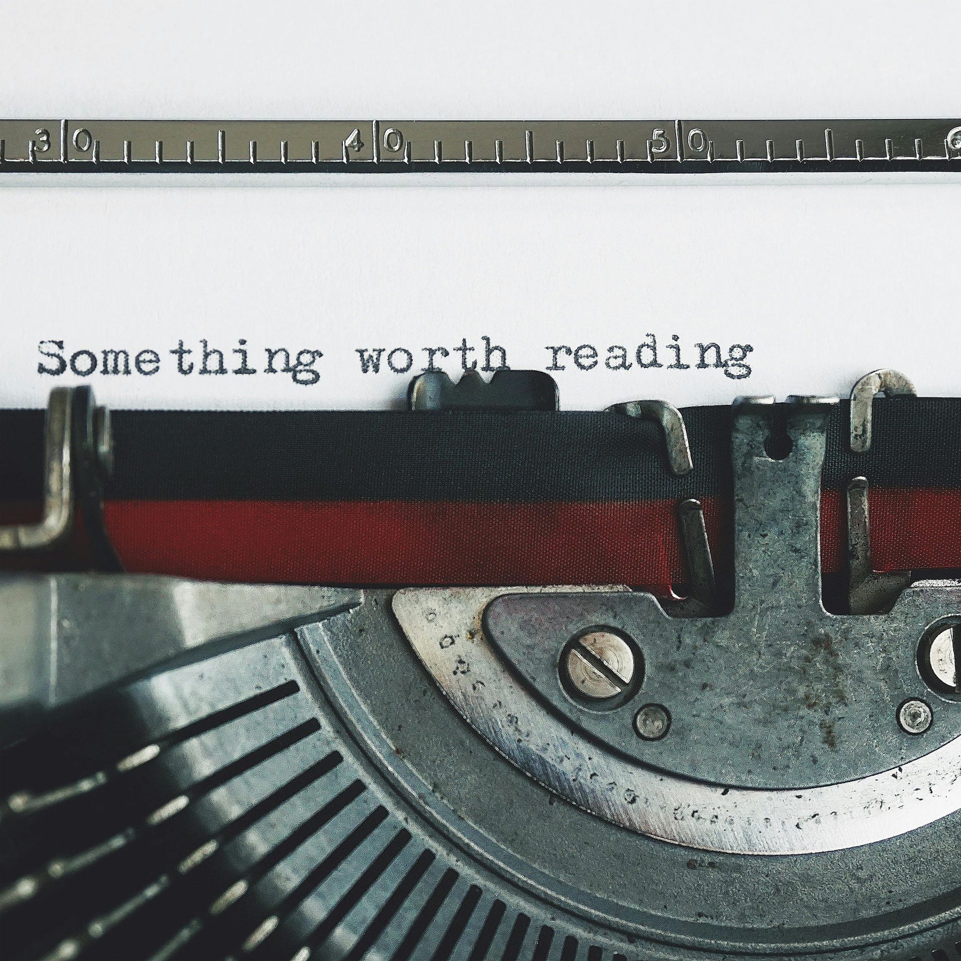 a typewriter with the words something worth reading typed on it