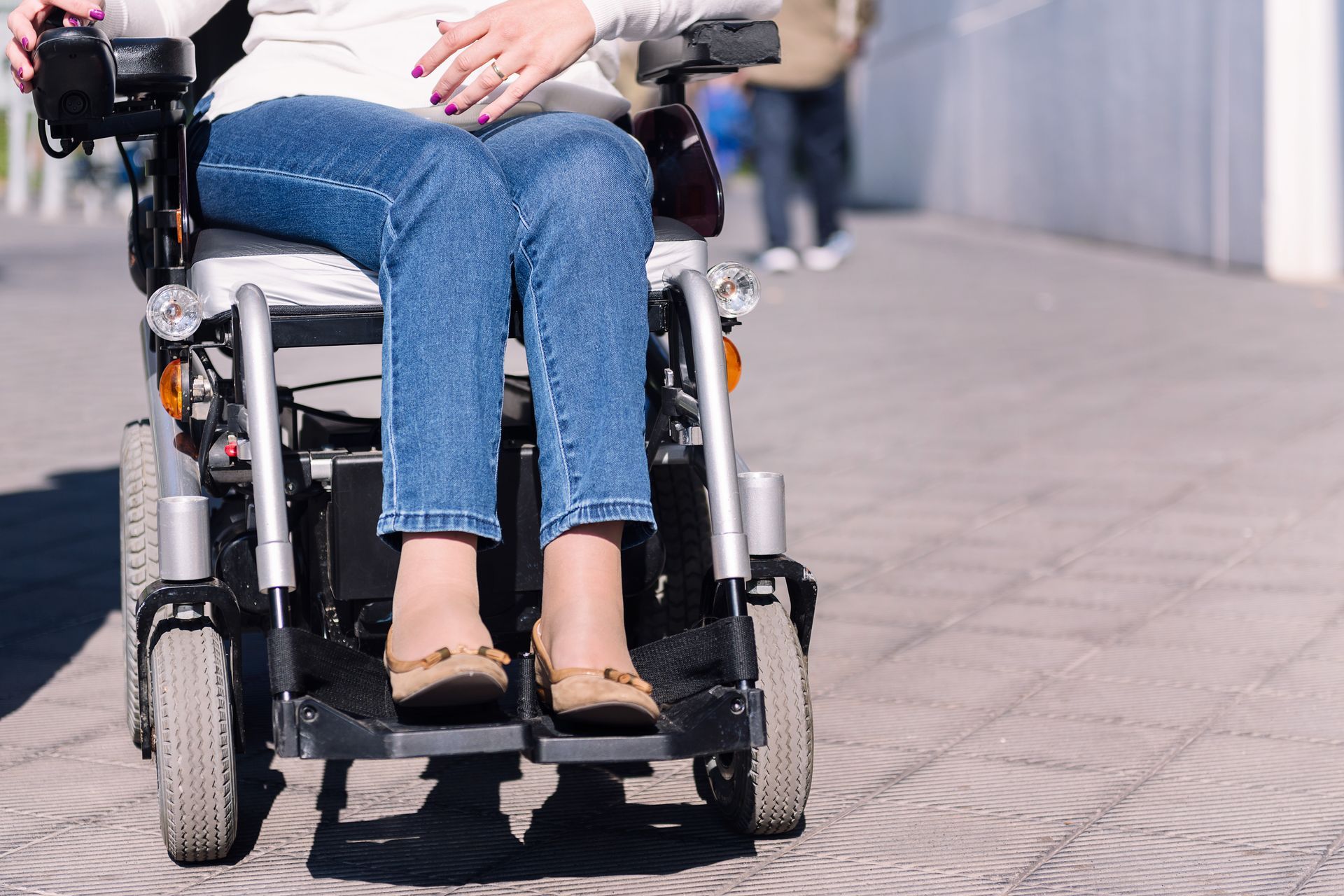 Woman using an electric wheelchair with space for text