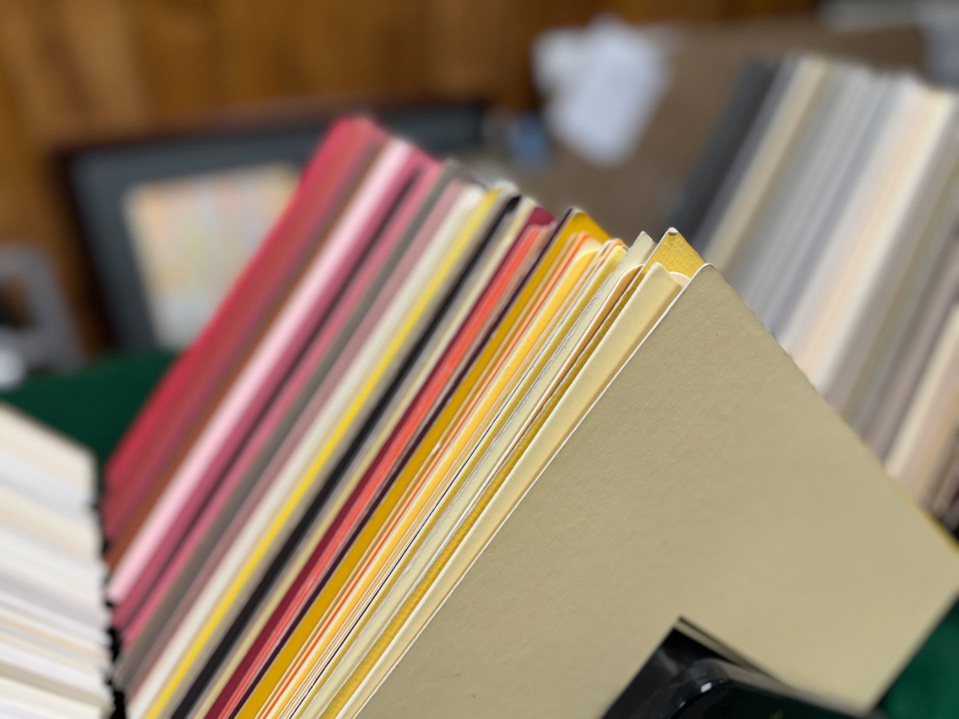 A bunch of different colored papers are stacked on top of each other on a table.
