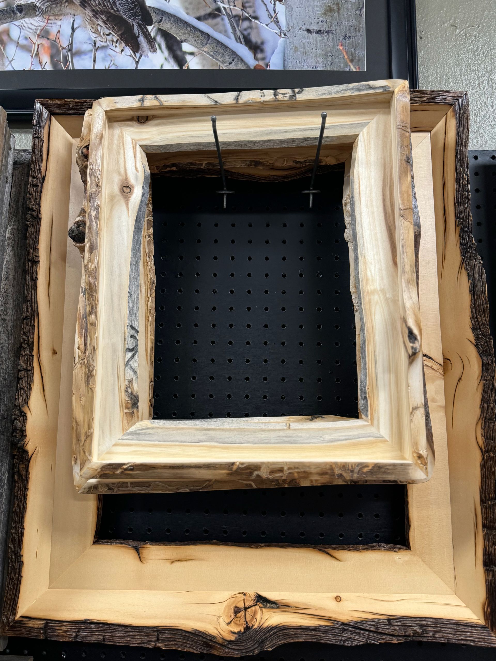 Two wooden frames are stacked on top of each other