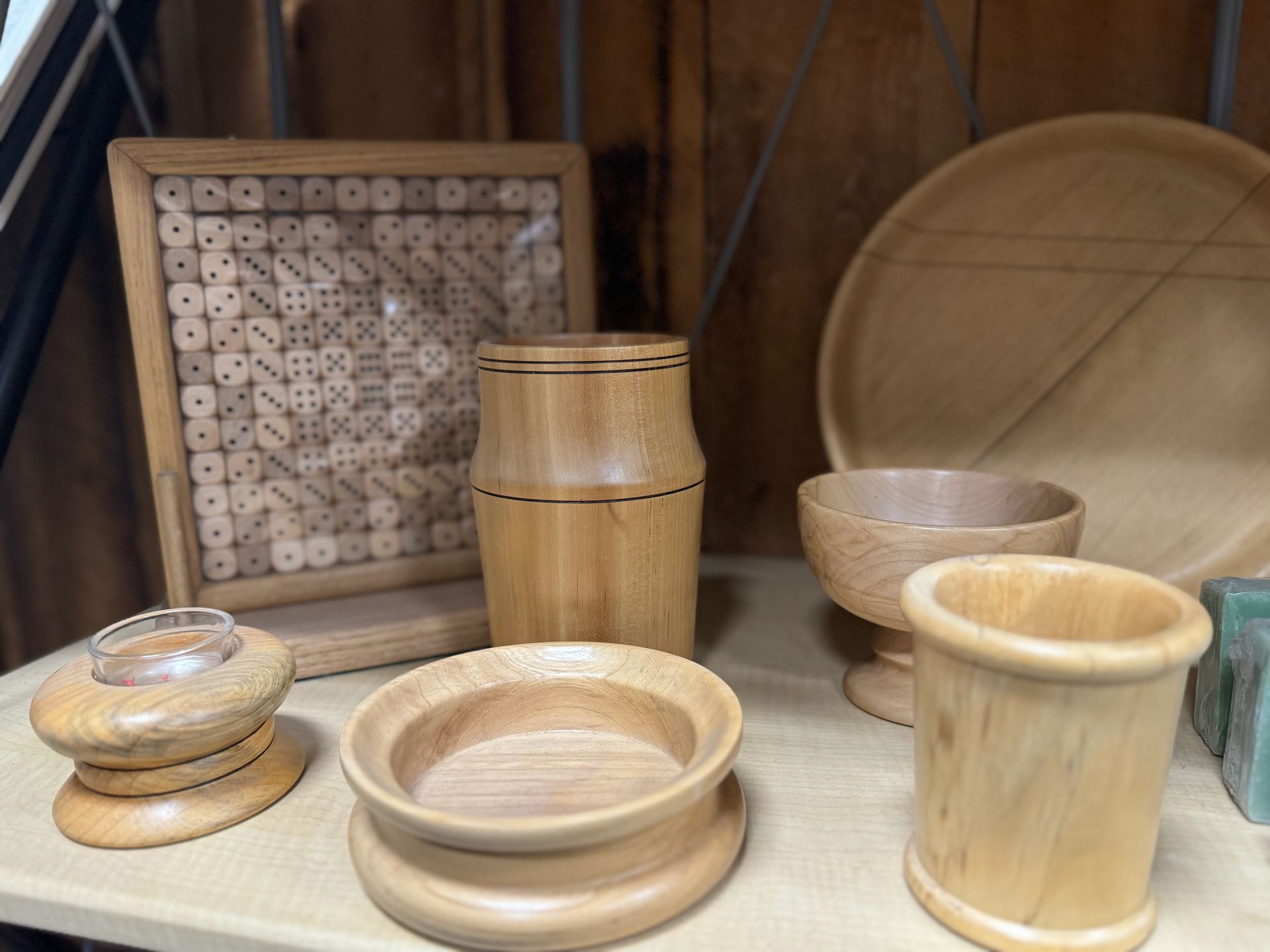 A table topped with a variety of wooden objects.