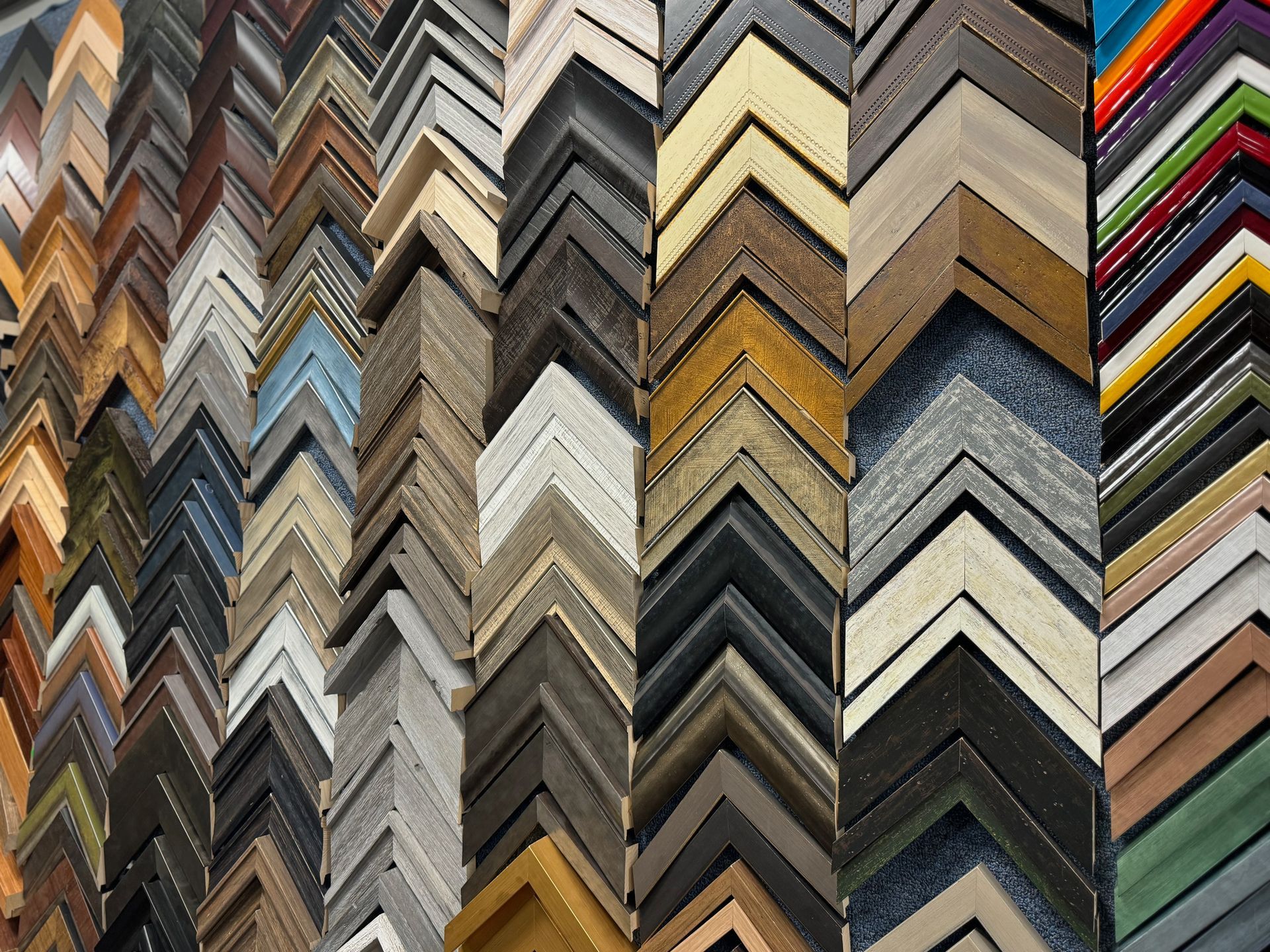 A bunch of different types of picture frames are lined up in a row.