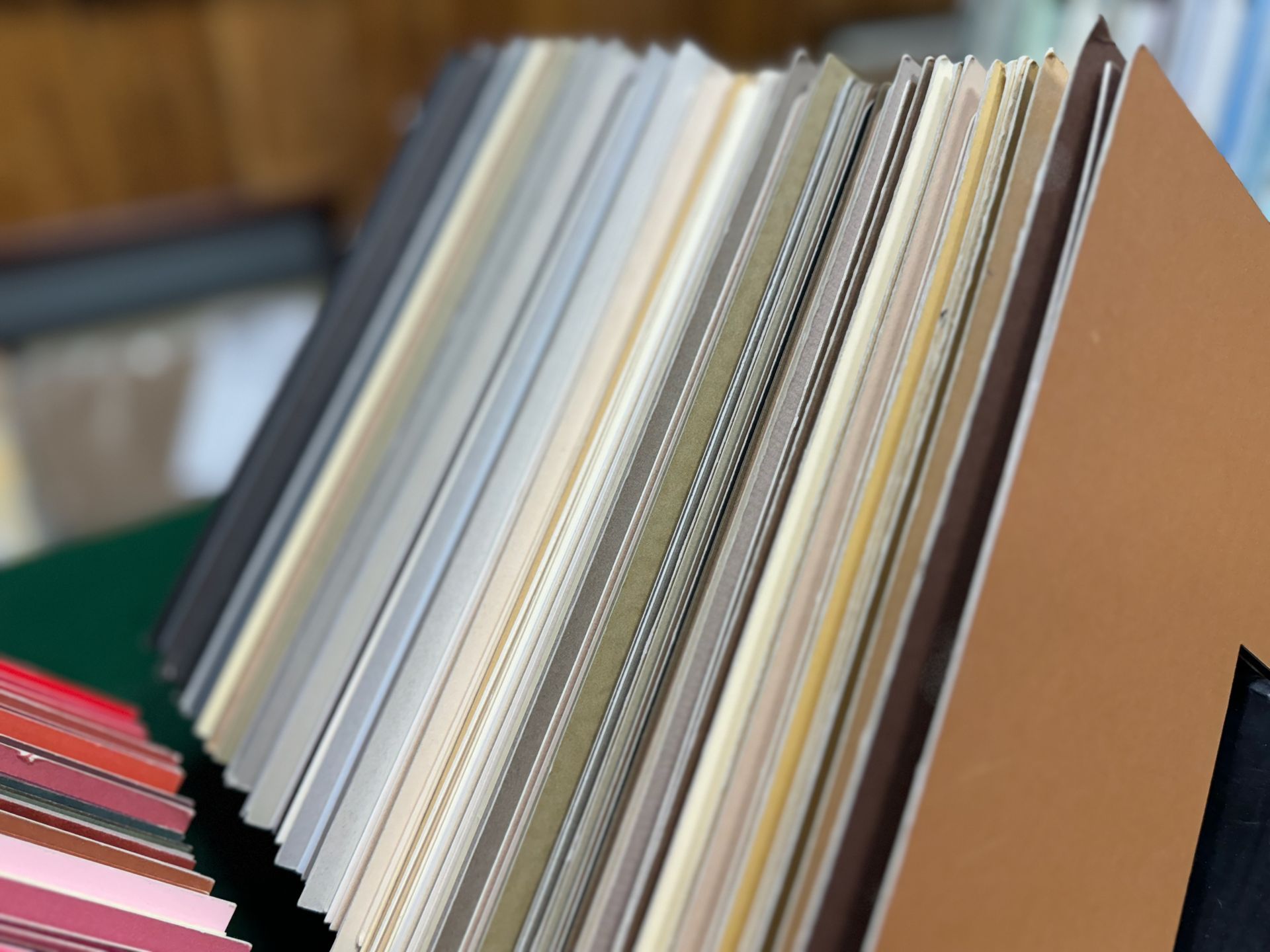 A stack of books with different colors on a table