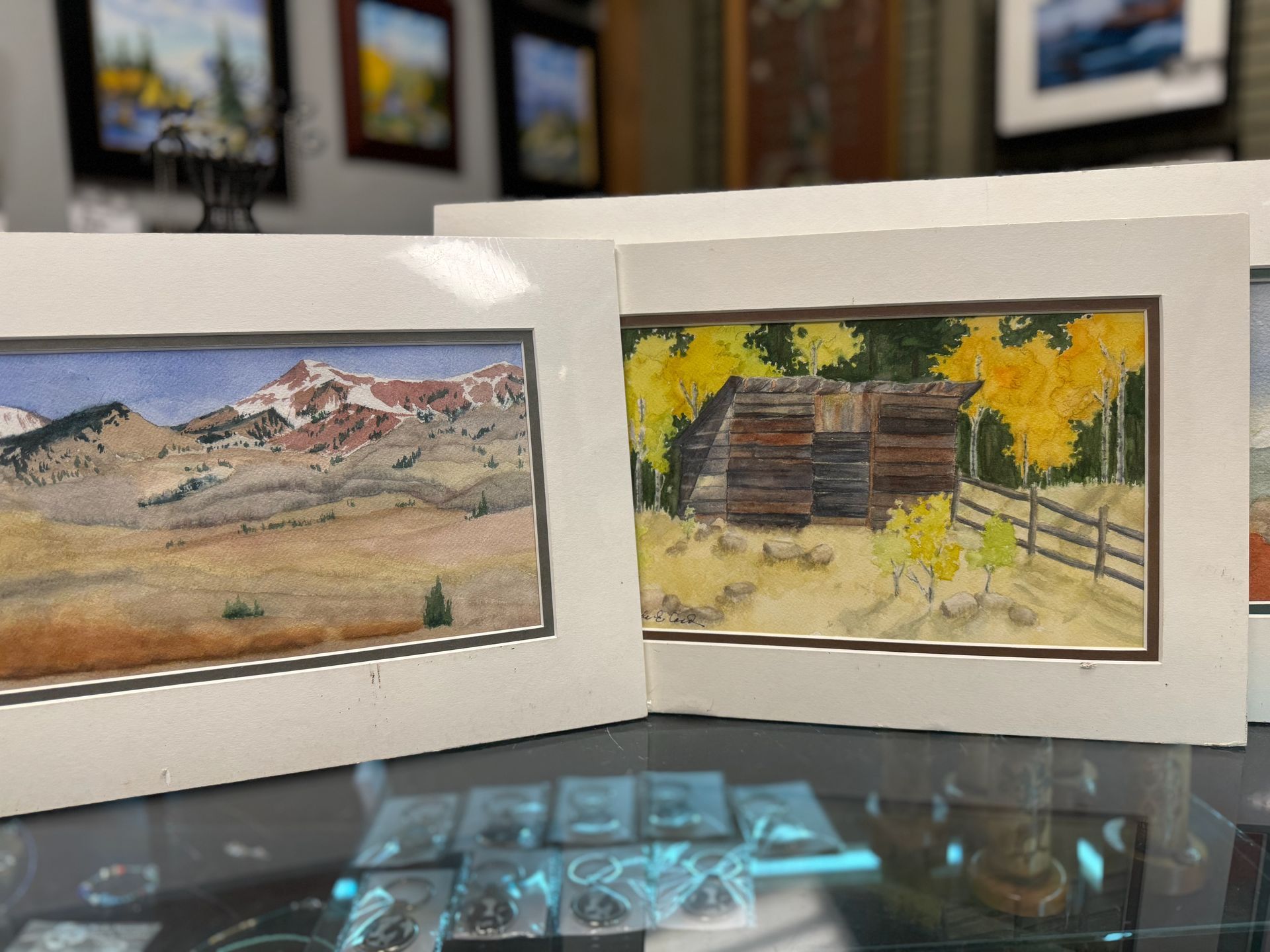 A couple of paintings are sitting on top of a table.