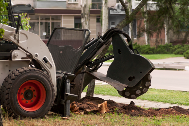 A stump grinder is being used to remove a tree stump from the ground. A stump grinder is being used to remove a tree stump from the ground.