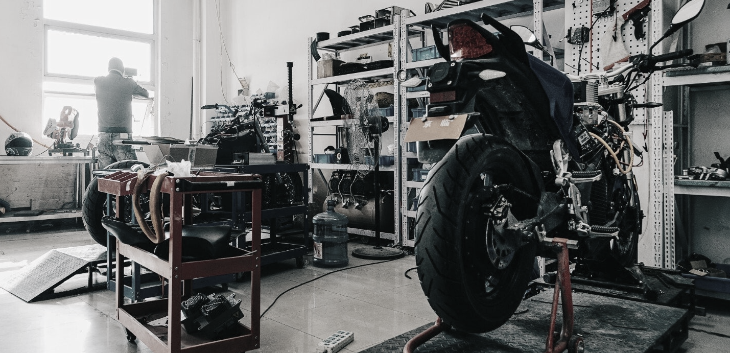 Urban Series electric motorcycle is sitting on a stand in a garage.