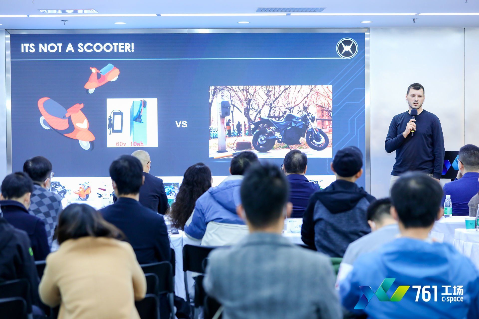 Sebastian Chrobok is giving a presentation to a group of people.