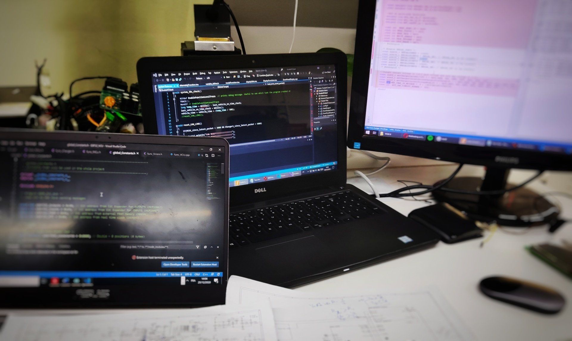 A computer monitor and a laptop are on a desk