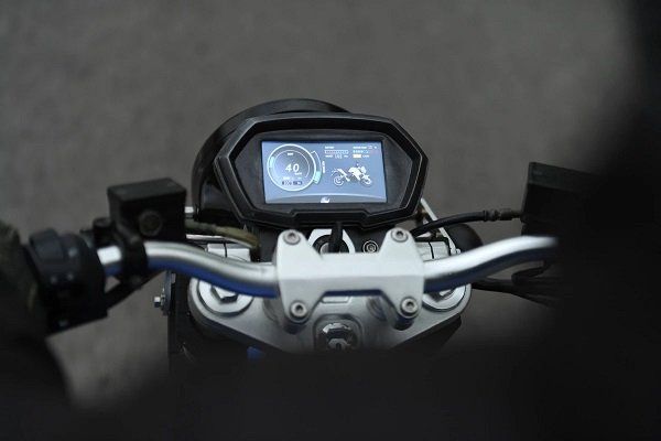 A close up of a motorcycle dashboard with a touchscreen display.