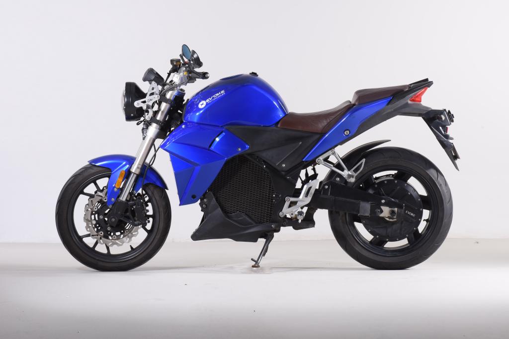 A blue Urban Classic electric motorcycle is sitting on a white surface.
