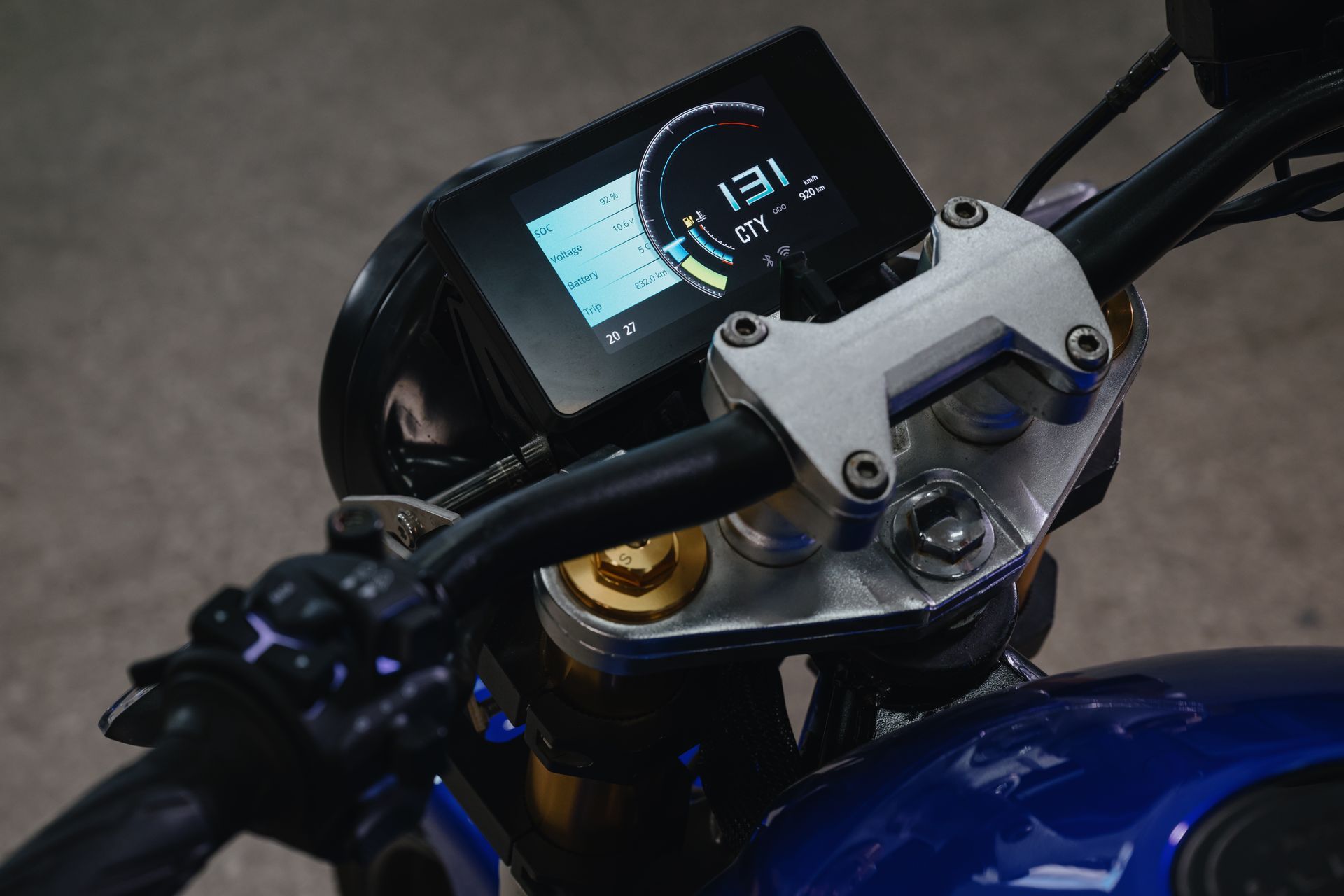 A close-up of an Urban Classic electric motorcycle dashboard with a digital display.
