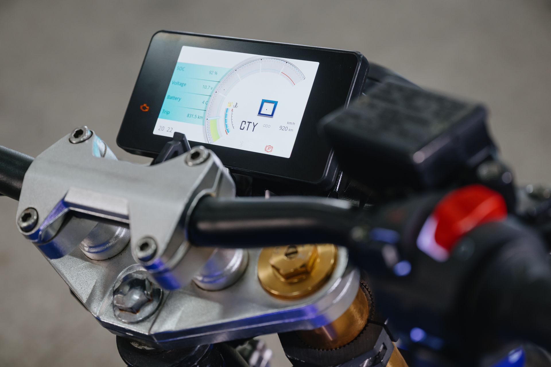 A close-up of an Urban Classic electric motorcycle dashboard with a digital display.