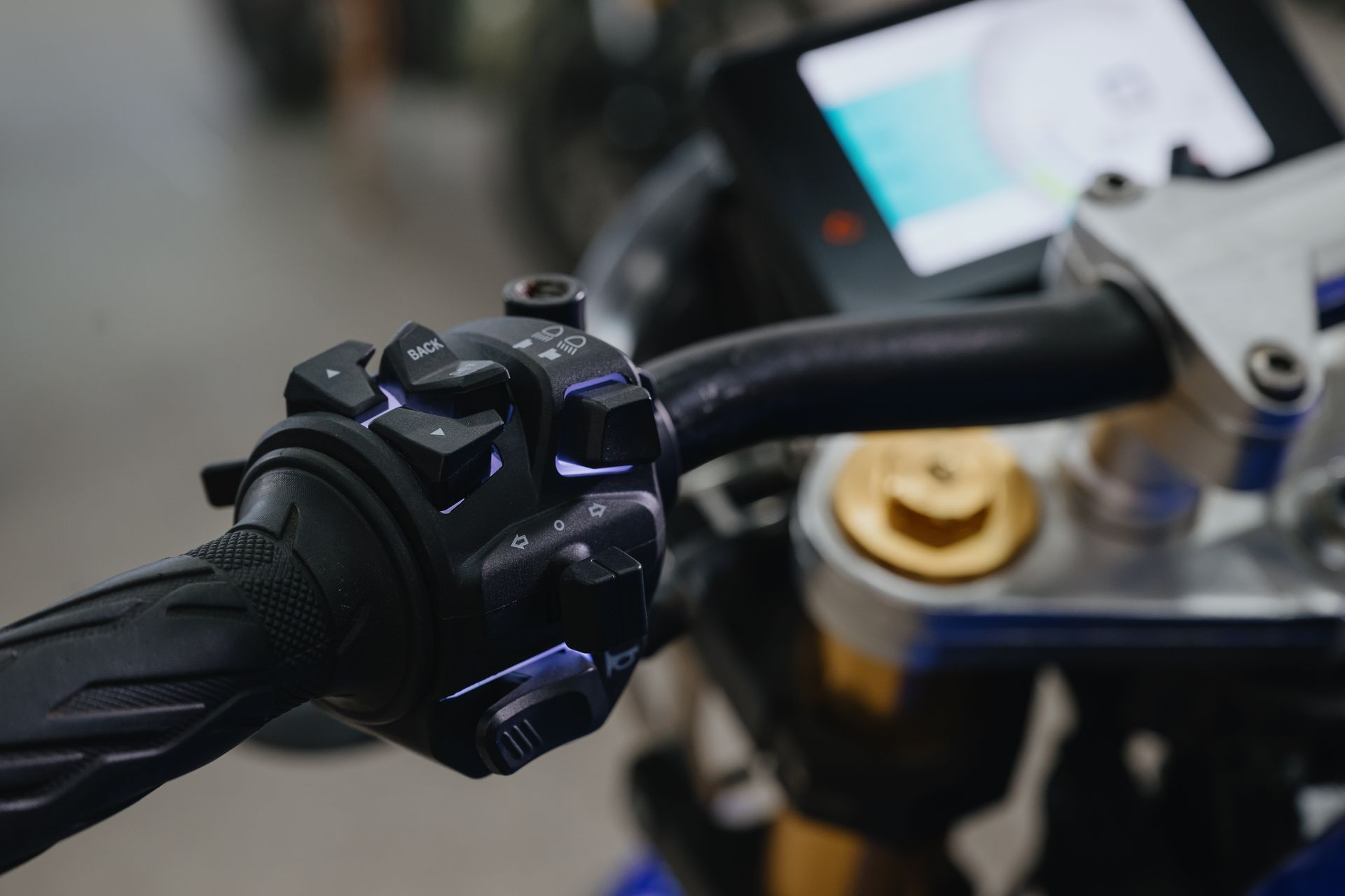 A close up of a motorcycle handlebar with a remote control on it.