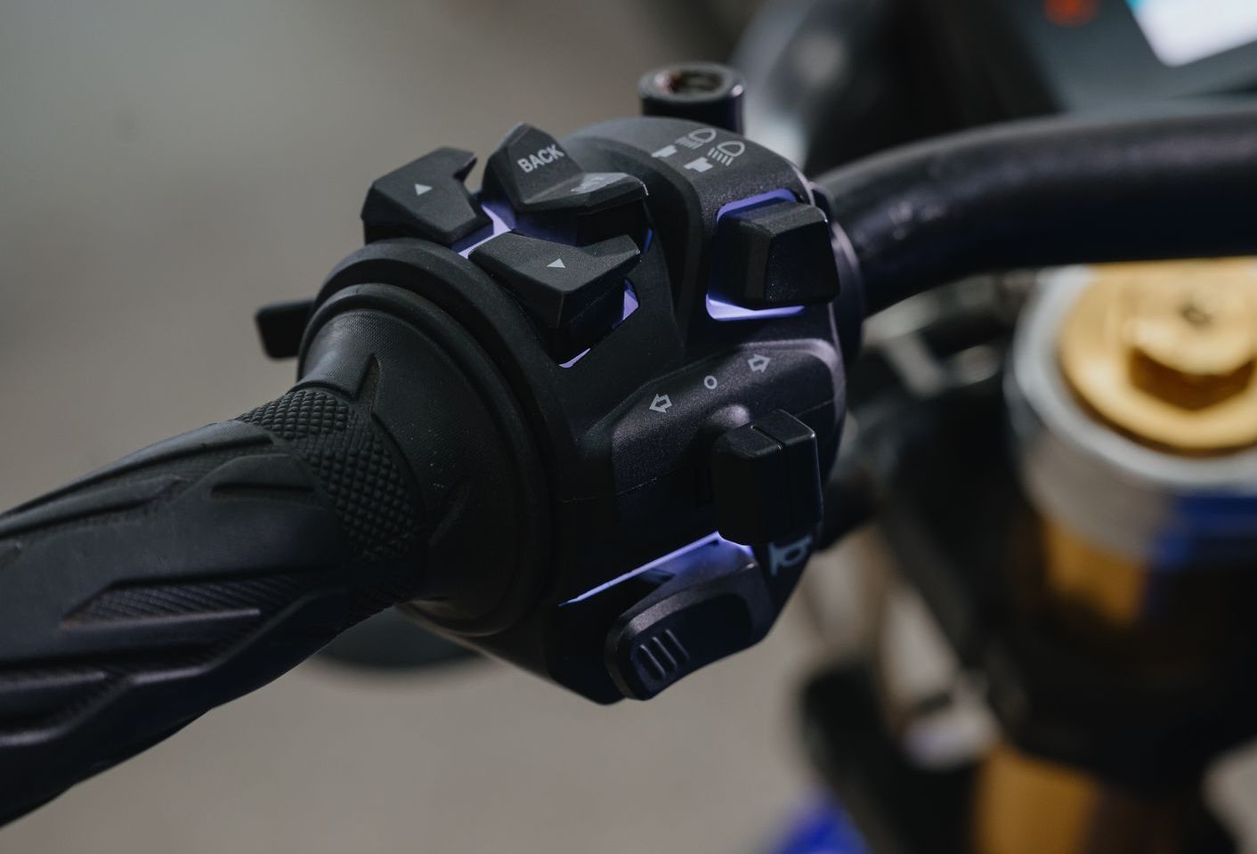 A close-up of an Urban Classic electric motorcycle's handlebars and controls.