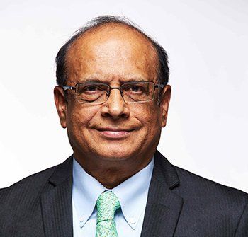 A man in a suit and tie is smiling for the camera.