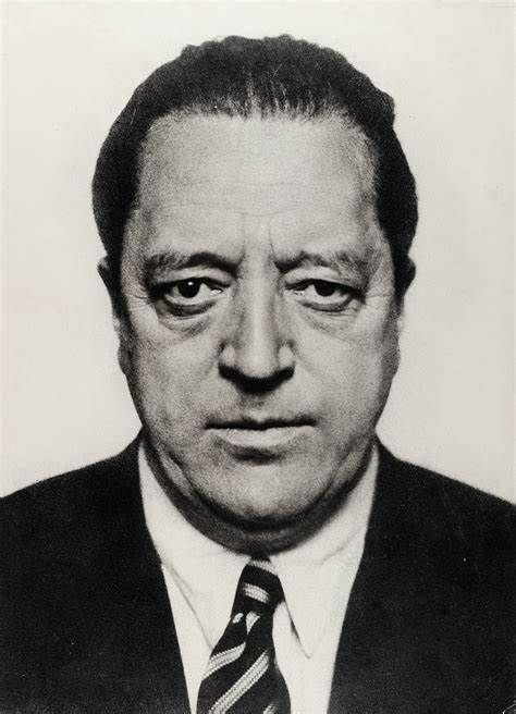 A black and white photo of a man in a suit and tie