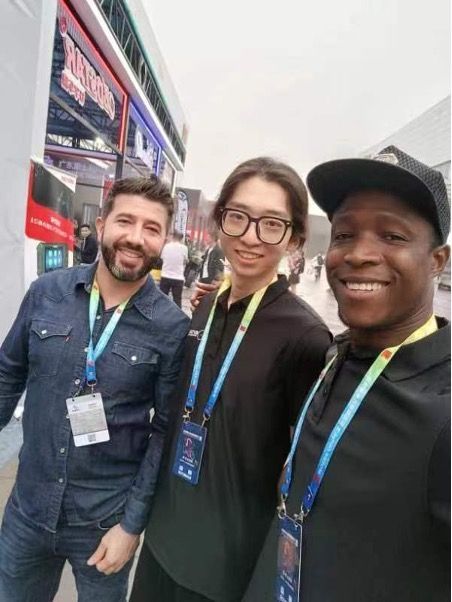 A group of people posing for a picture in front of a building