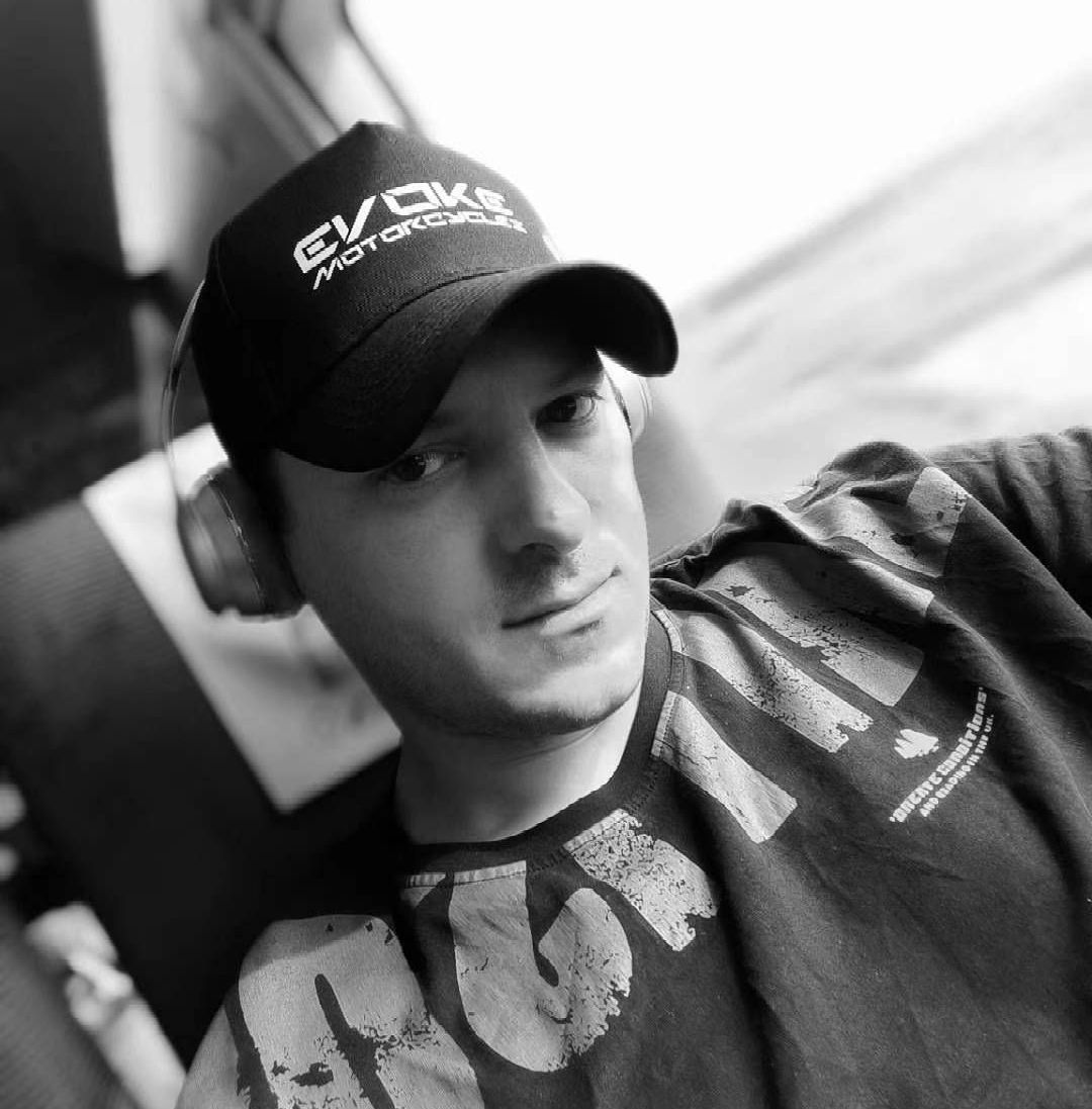 Sebastian Chrobok wearing a black hat with the evoke motorcycles on it