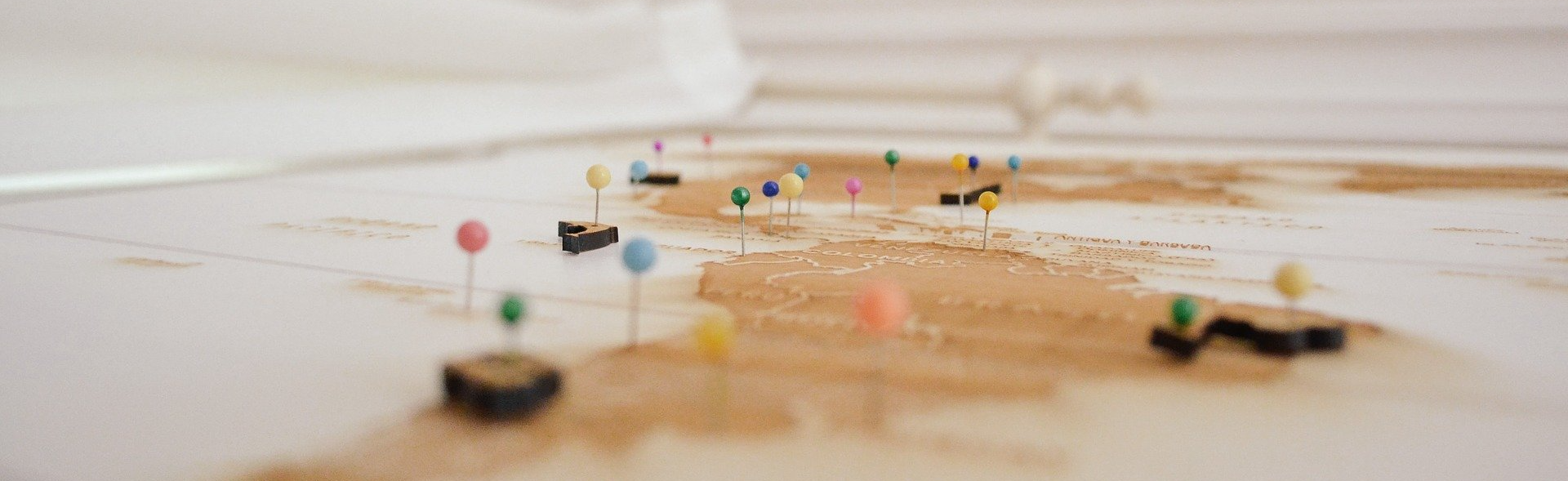 A map of the world with pins on it.