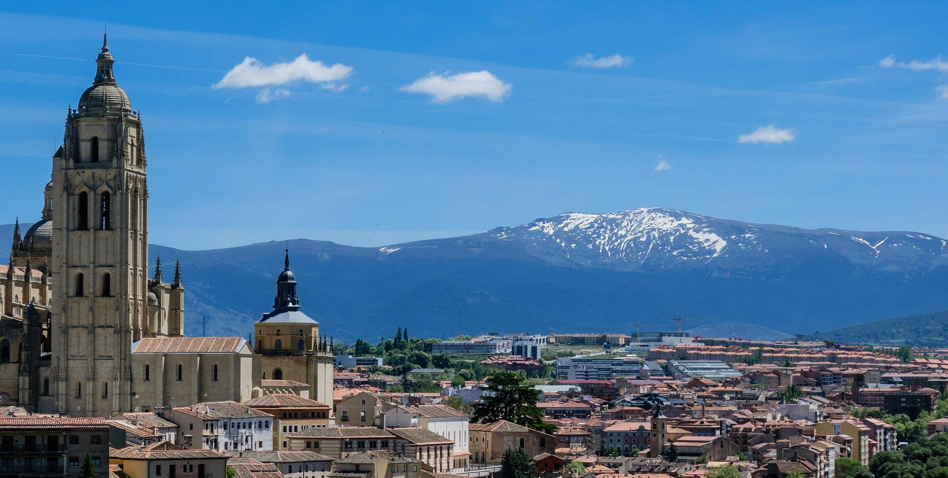 An aerial view of a city with mountains in the background.