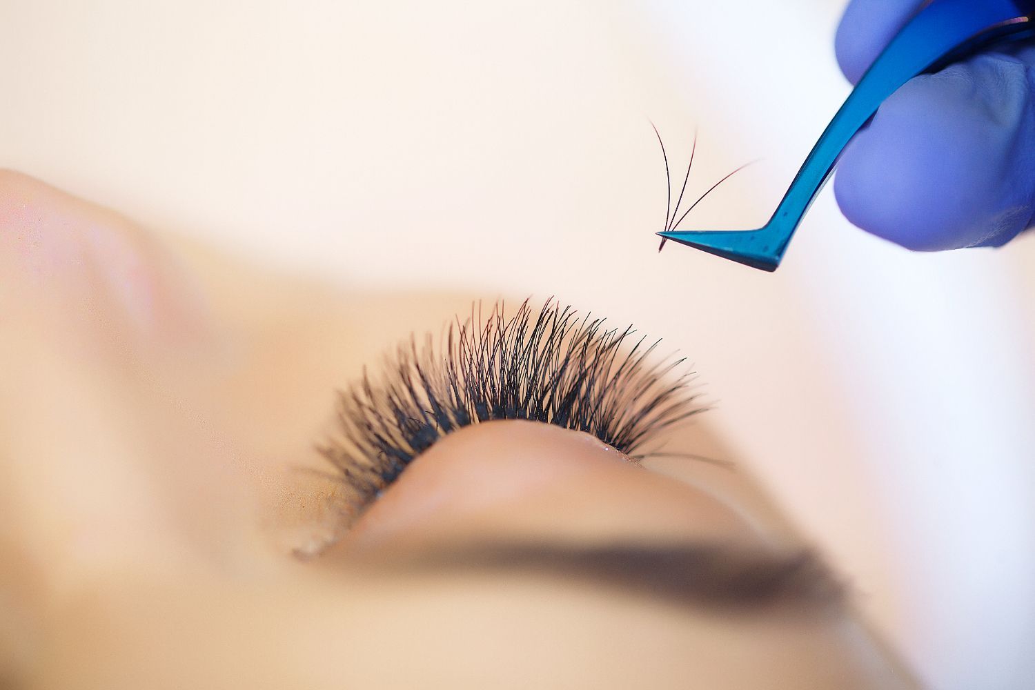A close up of a woman getting her eyelashes done.