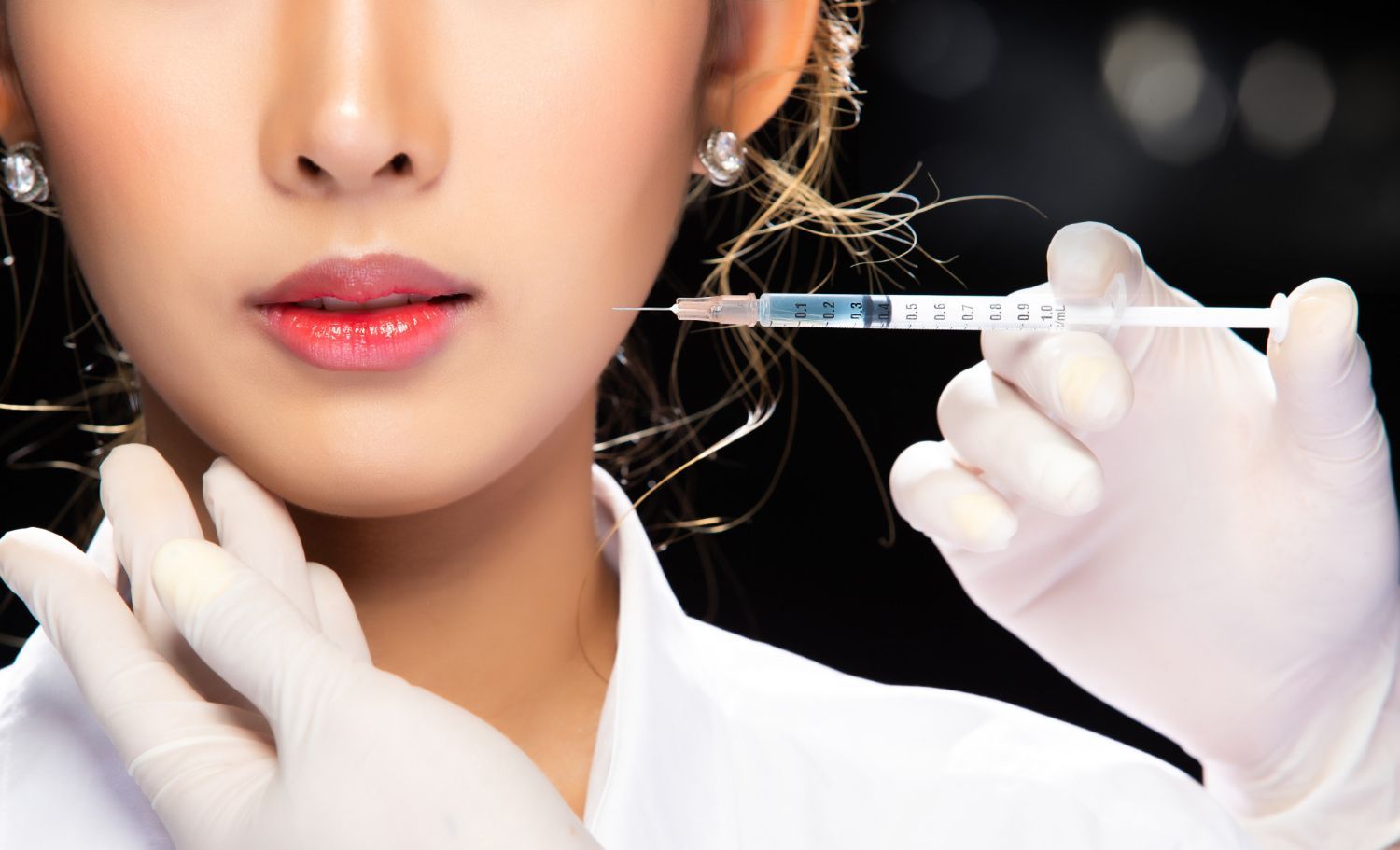 A woman is getting a botox injection in her face.