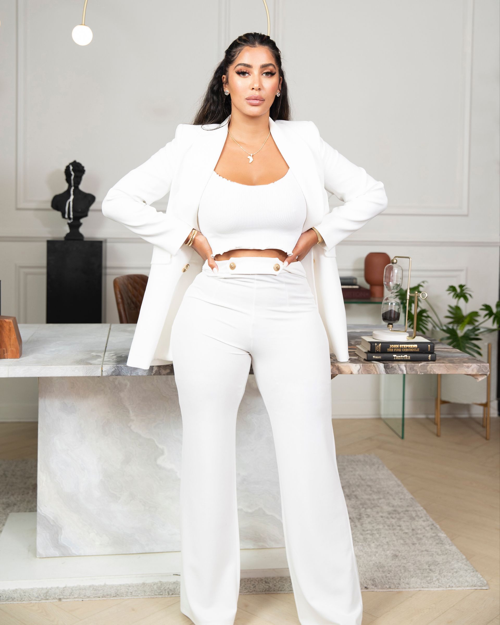 a woman in a white shirt standing in an office