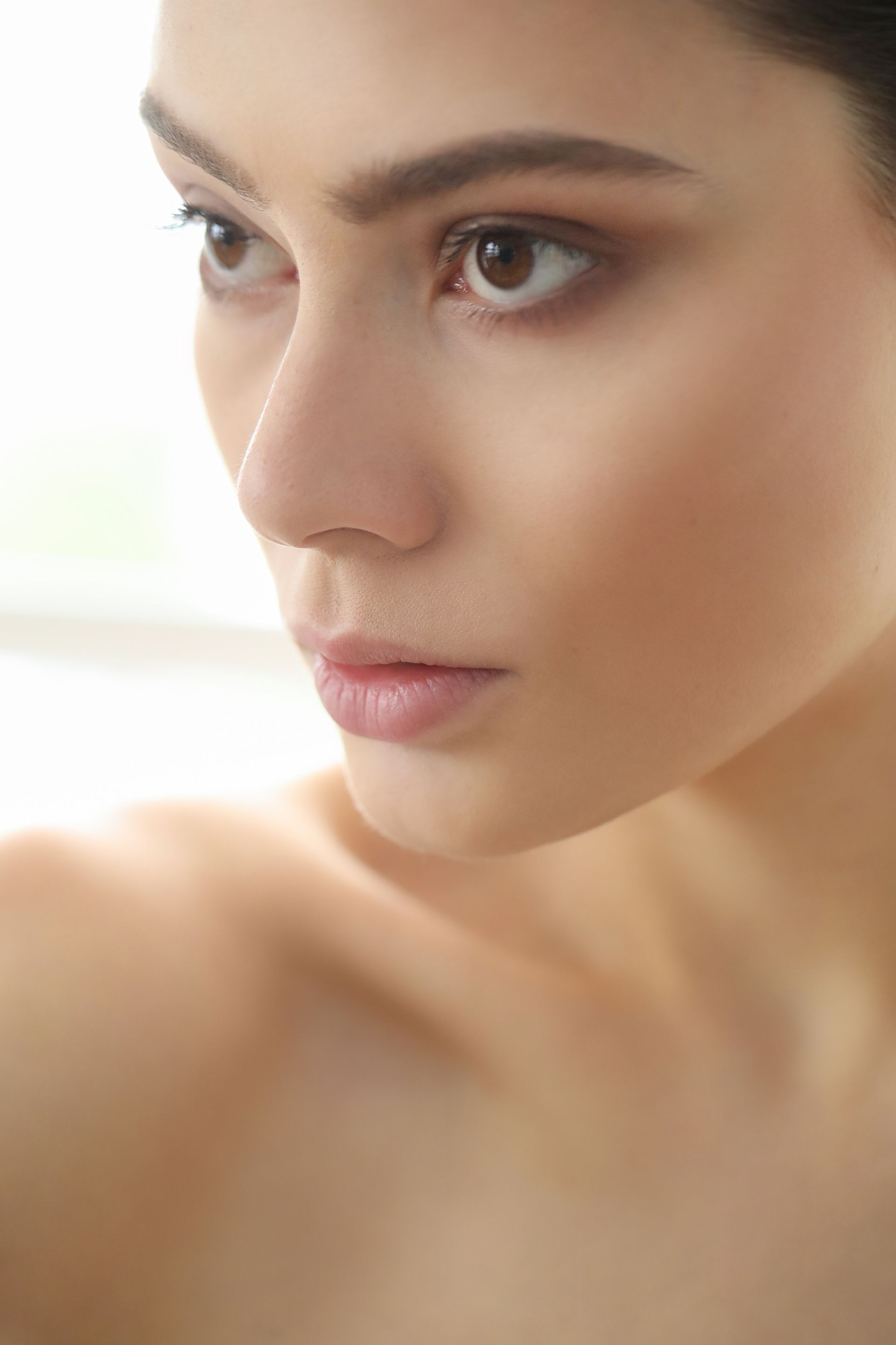 a close up of a woman 's face with a white background