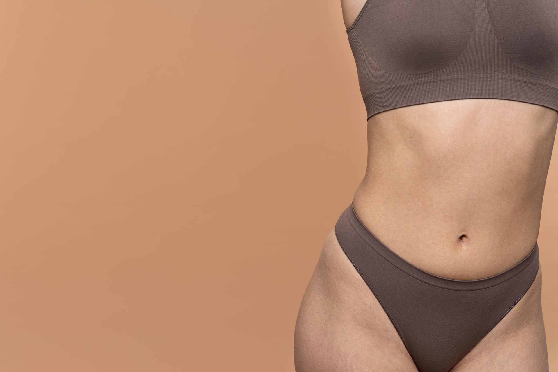 a woman 's torso is shown with a brown background