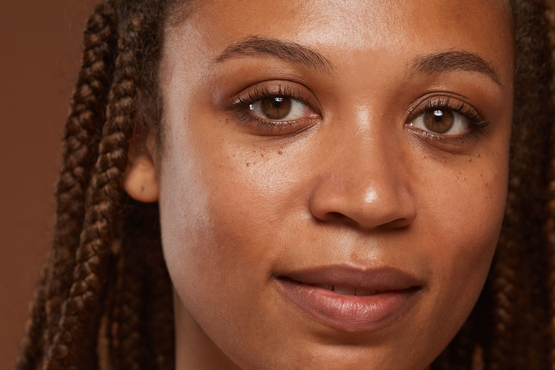 a close up of a woman 's face with braids