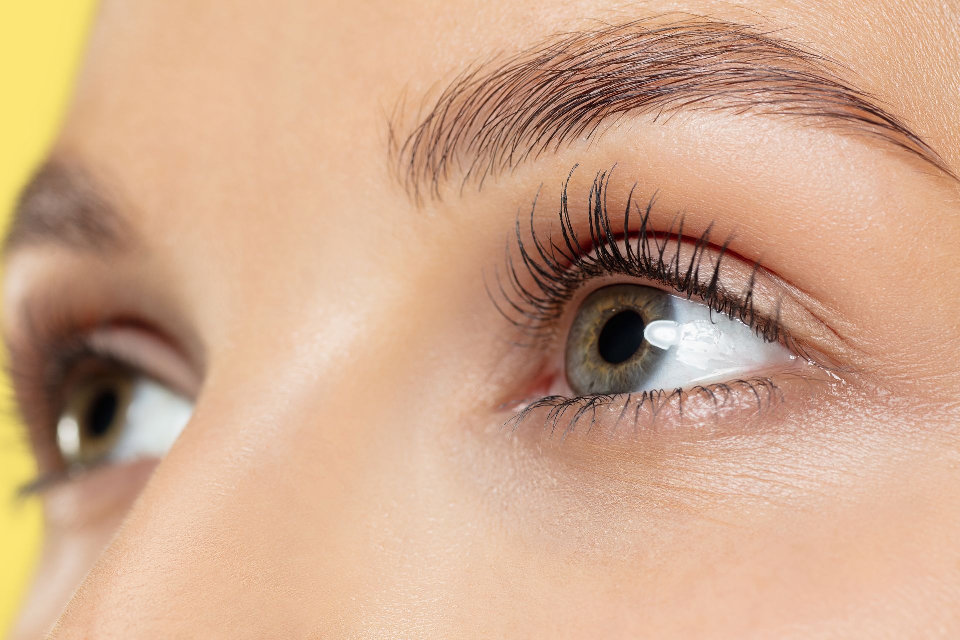 a close up of a woman 's eye with long eyelashes