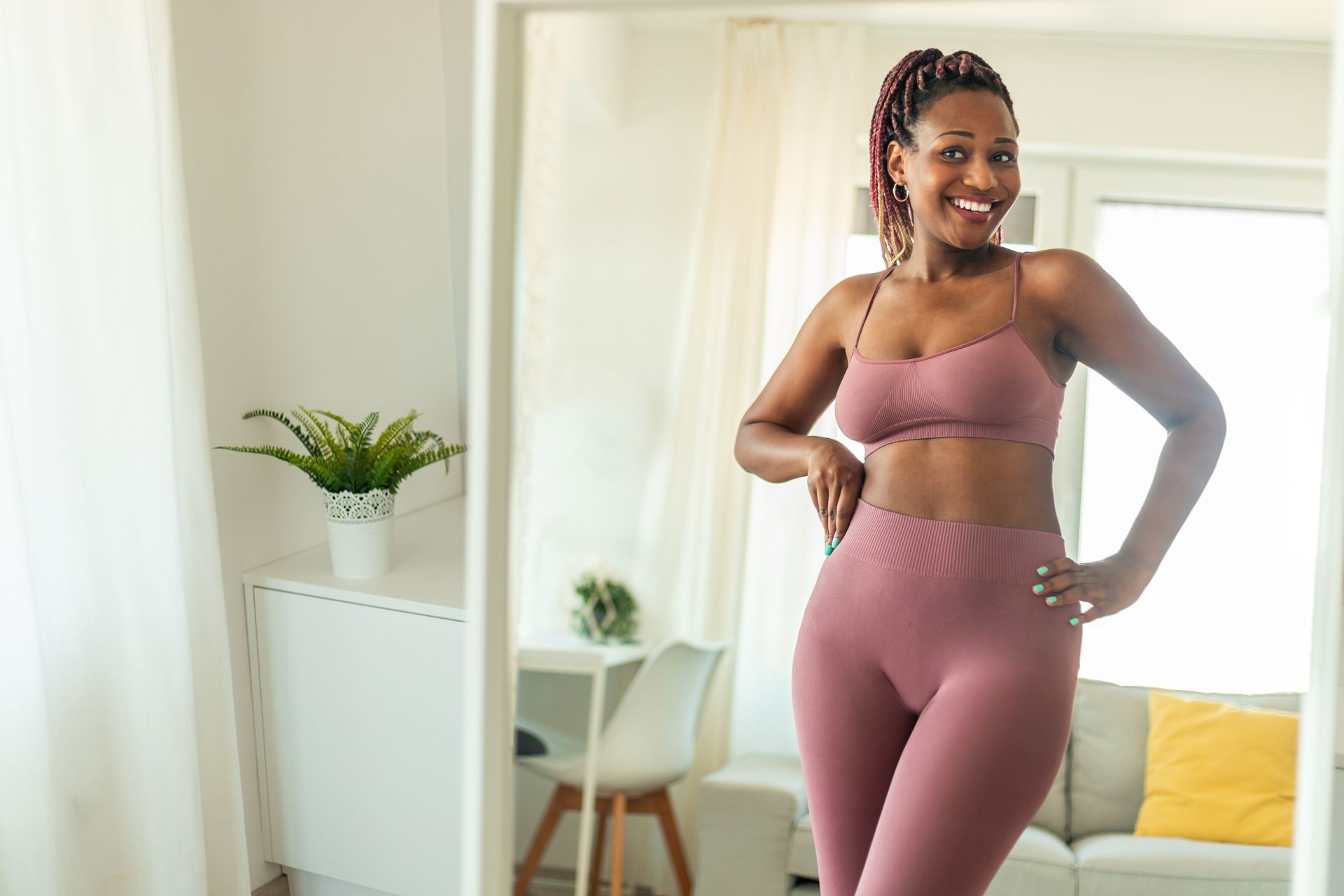 a woman is looking at herself in a mirror and smiling