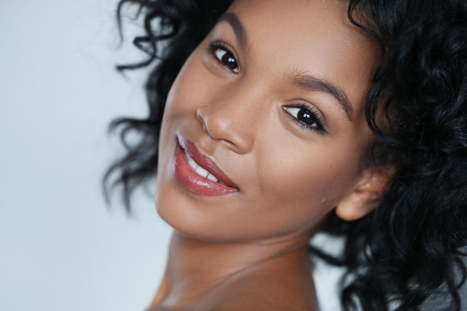 a close up of a woman 's face with her eyes closed