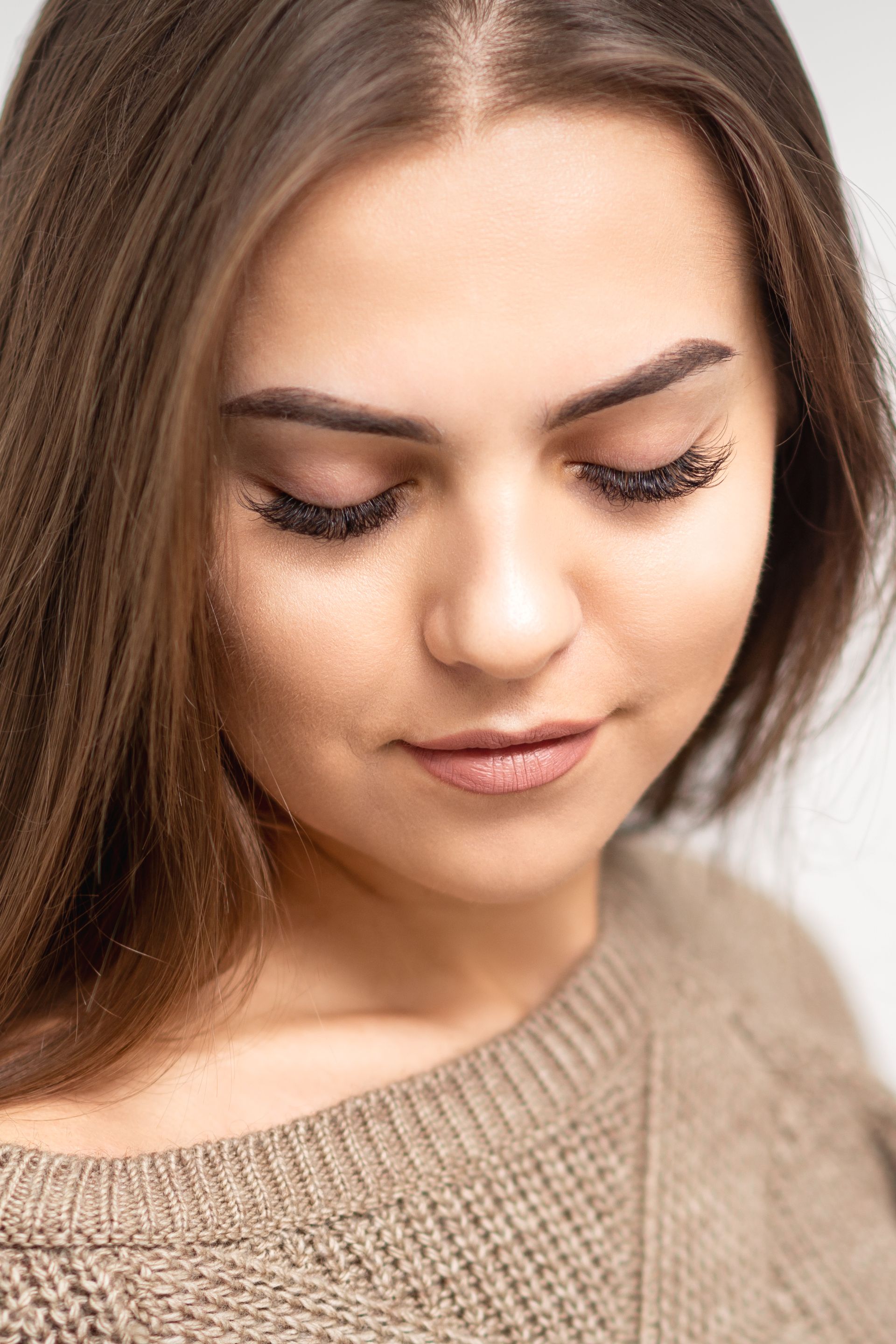 a close up of a woman 's face with her eyes closed