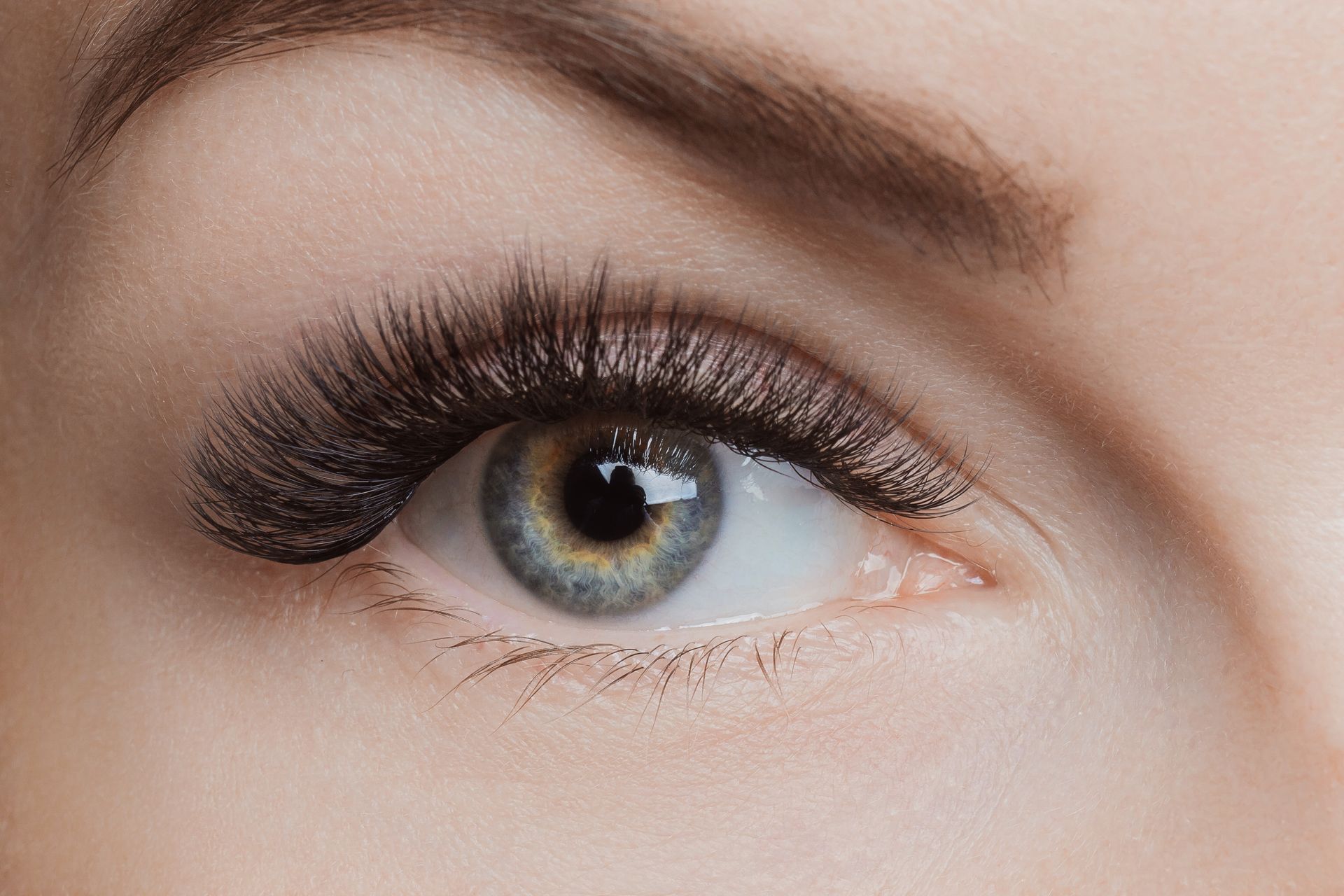 a close up of a woman 's eye with long eyelashes