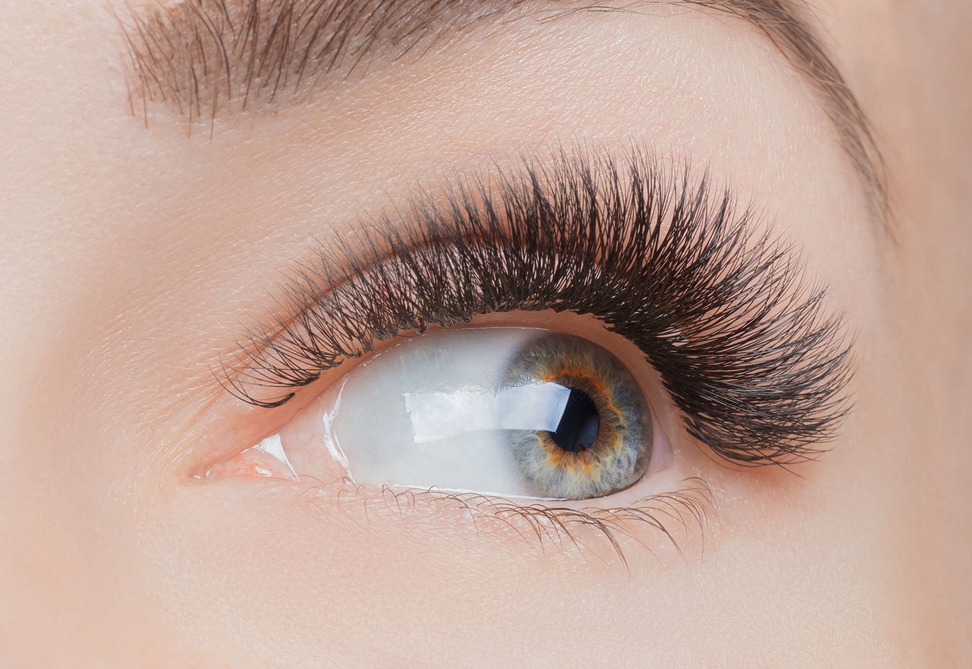 a close up of a woman 's eye with long eyelashes